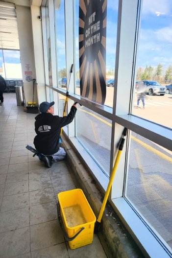 Best View window cleaner attentively cleaning the interior windows of Sobeys Grocery Stores in Charlottetown.